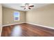 Bedroom featuring wood floors, ceiling fan, and natural light at 14315 Crestavista Ave, Clermont, FL 34714