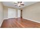 Bedroom featuring wood floors, a ceiling fan, and a double door closet at 14315 Crestavista Ave, Clermont, FL 34714