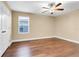 Bedroom with hardwood floors, ceiling fan, and a window letting in natural light at 14315 Crestavista Ave, Clermont, FL 34714