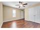 Bedroom with hardwood floors, ceiling fan, window and closet at 14315 Crestavista Ave, Clermont, FL 34714