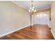 Elegant dining room with wood floors, decorative lighting, and wainscoting details at 14315 Crestavista Ave, Clermont, FL 34714