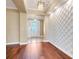 Elegant foyer with hardwood floors, a textured accent wall, and a stylish chandelier fixture at 14315 Crestavista Ave, Clermont, FL 34714