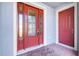 Close-up of a front door featuring sidelights and transom window, with a storm door and decorative glass at 14315 Crestavista Ave, Clermont, FL 34714