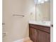 A half bath featuring a dark wood vanity and a white quartz countertop at 14315 Crestavista Ave, Clermont, FL 34714