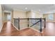 Hallway and stairwell featuring wood flooring and black iron railings at 14315 Crestavista Ave, Clermont, FL 34714