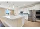 Bright kitchen featuring white cabinetry, stainless steel appliances, and a large island at 14315 Crestavista Ave, Clermont, FL 34714