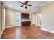 Main bedroom featuring hardwood floors, ceiling fan, and wet bar with an ensuite bathroom at 14315 Crestavista Ave, Clermont, FL 34714