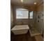 Bathroom features a free standing tub and glass enclosed shower at 14339 Windchime Ln, Orlando, FL 32837