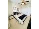 Bedroom with a queen bed, closet, and ceiling fan; black and white decor at 14339 Windchime Ln, Orlando, FL 32837