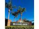 Hunter's Creek community sign with palm trees set against a clear blue sky at 14339 Windchime Ln, Orlando, FL 32837