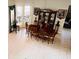 Dining area with wood table, chairs, china cabinet and French doors to the patio at 14339 Windchime Ln, Orlando, FL 32837