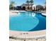 Community pool with zero entry featuring clear blue water, surrounded by a tiled deck at 14339 Windchime Ln, Orlando, FL 32837