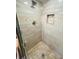 Gorgeous tiled shower stall with built-in niche and modern fixtures at 14339 Windchime Ln, Orlando, FL 32837