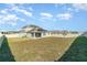 Large backyard with fencing, featuring newly installed solar panels on the roof at 14418 Bayuk Way, Winter Garden, FL 34787