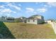 Spacious backyard featuring new solar panels on the roof and a white fence at 14418 Bayuk Way, Winter Garden, FL 34787