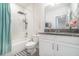 This bathroom features a shower-tub combo, granite counters, a modern sink, and tiled floors at 14418 Bayuk Way, Winter Garden, FL 34787