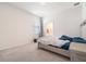 Neutral bedroom with adjoining bathroom featuring neutral carpet, a bedside table, and a serene atmosphere at 14418 Bayuk Way, Winter Garden, FL 34787