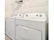 Well-lit laundry room features a modern, white washer and dryer set at 14418 Bayuk Way, Winter Garden, FL 34787