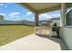 Outdoor kitchen on a covered patio overlooking the lawn at 14418 Bayuk Way, Winter Garden, FL 34787