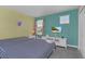 Bright bedroom featuring two twin beds, television and colorful decor at 1555 Flange Dr, Davenport, FL 33896