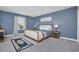 Bedroom with blue walls featuring a queen sized bed, and soft rug at 1555 Flange Dr, Davenport, FL 33896