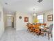 Bright dining room with modern lighting and a view into the entry foyer at 1555 Flange Dr, Davenport, FL 33896