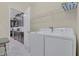 Convenient laundry room with washer, dryer, and shelving for storage at 1555 Flange Dr, Davenport, FL 33896