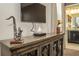 Living room decor featuring a television and a vintage saxophone statue next to the bathroom at 1555 Flange Dr, Davenport, FL 33896