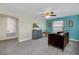 Living room featuring a teal accent wall, a ceiling fan, and comfortable seating at 1555 Flange Dr, Davenport, FL 33896