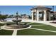 Community pool area featuring a fountain, pavilion, lounge chairs, and palm trees on a sunny day at 1555 Flange Dr, Davenport, FL 33896