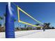 A beach volleyball court ready for a friendly game on the sand with palm trees in the background at 1555 Flange Dr, Davenport, FL 33896