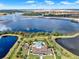 An aerial view of a grand estate featuring a pool, tennis court, and private ponds surrounded by trees at 16089 Parkwyn St, Winter Garden, FL 34787