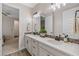 Bathroom featuring dual sinks, white countertops, and decorative backsplash at 16089 Parkwyn St, Winter Garden, FL 34787