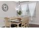 Charming dining room with wooden table, seating for six, and natural light streaming through the windows at 16089 Parkwyn St, Winter Garden, FL 34787