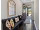 Elegant entryway featuring hardwood floors, a decorative mirror, and stylish bench seating at 16089 Parkwyn St, Winter Garden, FL 34787