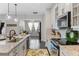 Well-equipped kitchen with stainless steel appliances, a decorative backsplash, and a view into the dining area at 16089 Parkwyn St, Winter Garden, FL 34787