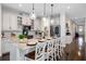 Well-lit kitchen featuring a large island with seating, stainless steel appliances, and modern fixtures at 16089 Parkwyn St, Winter Garden, FL 34787