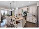 Stylish kitchen featuring granite countertops, a large island with seating, and modern pendant lighting at 16089 Parkwyn St, Winter Garden, FL 34787