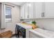 Laundry room with white cabinets, sink, modern washer and dryer, and natural light from the window at 16089 Parkwyn St, Winter Garden, FL 34787