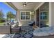 Cozy covered patio featuring plush seating, ceiling fan, outdoor television and decorative area rug at 16089 Parkwyn St, Winter Garden, FL 34787