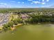 Aerial view of a waterfront community featuring lush greenery and lake access with private docks at 162 Lago Vista Blvd, Casselberry, FL 32707