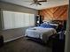 Cozy bedroom featuring a wood accent wall, ceiling fan, and a comfortable bed with blue pillows at 162 Lago Vista Blvd, Casselberry, FL 32707