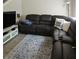 Relaxing living room featuring a sectional sofa, entertainment center, and accent rug at 162 Lago Vista Blvd, Casselberry, FL 32707