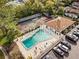 Aerial view of the community pool showcasing a large swimming area, parking, and lounge chairs at 162 Lago Vista Blvd, Casselberry, FL 32707