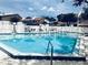 Community pool view featuring clear blue water and surrounding seating area at 162 Lago Vista Blvd, Casselberry, FL 32707