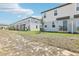 Townhome backyards featuring grass, privacy fences, and sliding glass doors at 16450 Bird Of Paradise Ave, Clermont, FL 34714