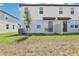 Townhome backyard featuring grass, young trees, privacy fences, and sliding glass doors at 16450 Bird Of Paradise Ave, Clermont, FL 34714