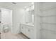 Bright bathroom featuring double vanity, walk-in closet, and tile flooring at 16450 Bird Of Paradise Ave, Clermont, FL 34714