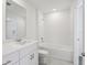 Bathroom with shower and tub combination, modern fixtures, and gray tile flooring at 16450 Bird Of Paradise Ave, Clermont, FL 34714