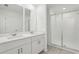 Contemporary bathroom showcasing double sinks, quartz countertop, and glass shower at 16450 Bird Of Paradise Ave, Clermont, FL 34714